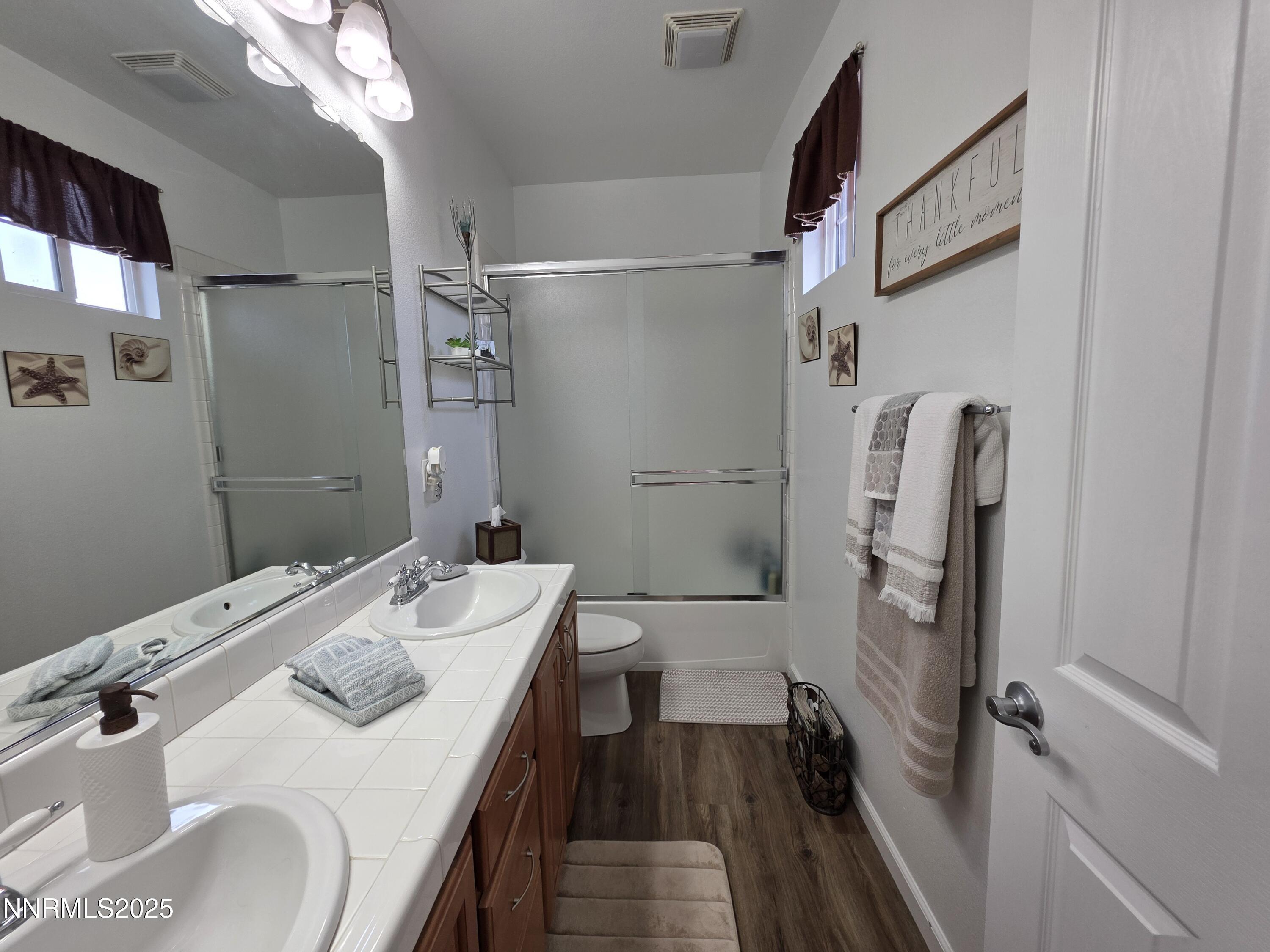 10677 Fire Poppy Circle Reno, NV 89521 - Photo 21 of 45 a bathroom with a sink a toilet and shower