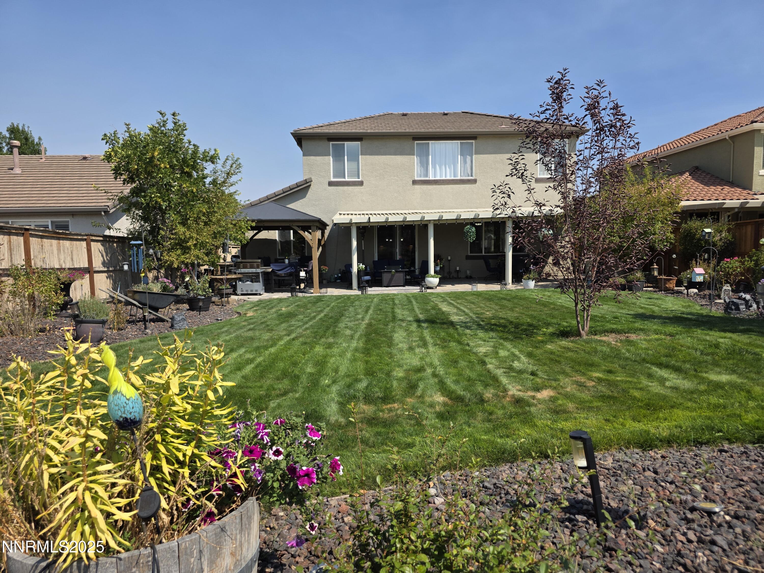 10677 Fire Poppy Circle Reno, NV 89521 - Photo 22 of 45 a view of a house with a big yard and potted plants