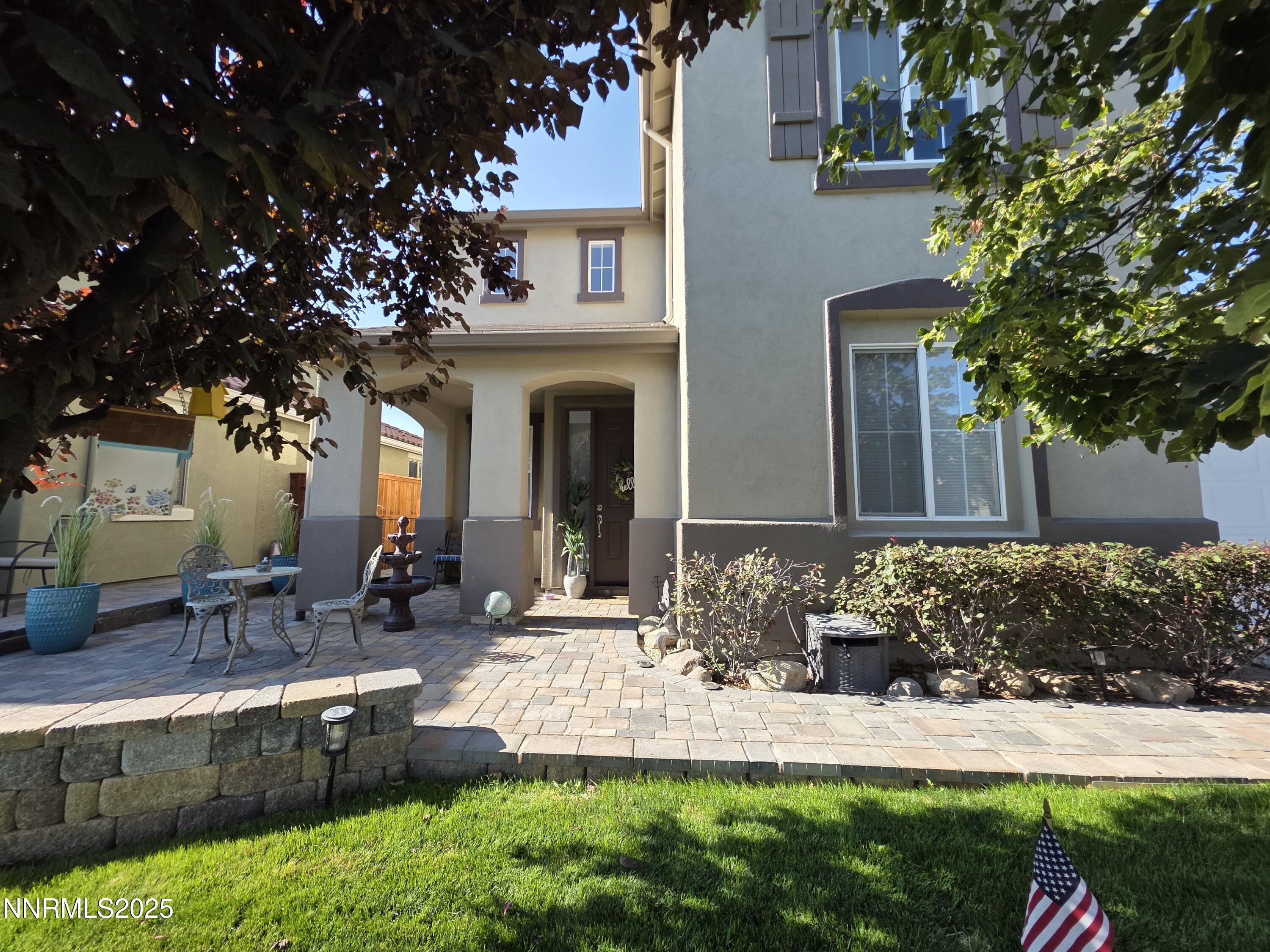 10677 Fire Poppy Circle Reno, NV 89521 - Photo 3 of 45 a front view of a house with a garden and patio