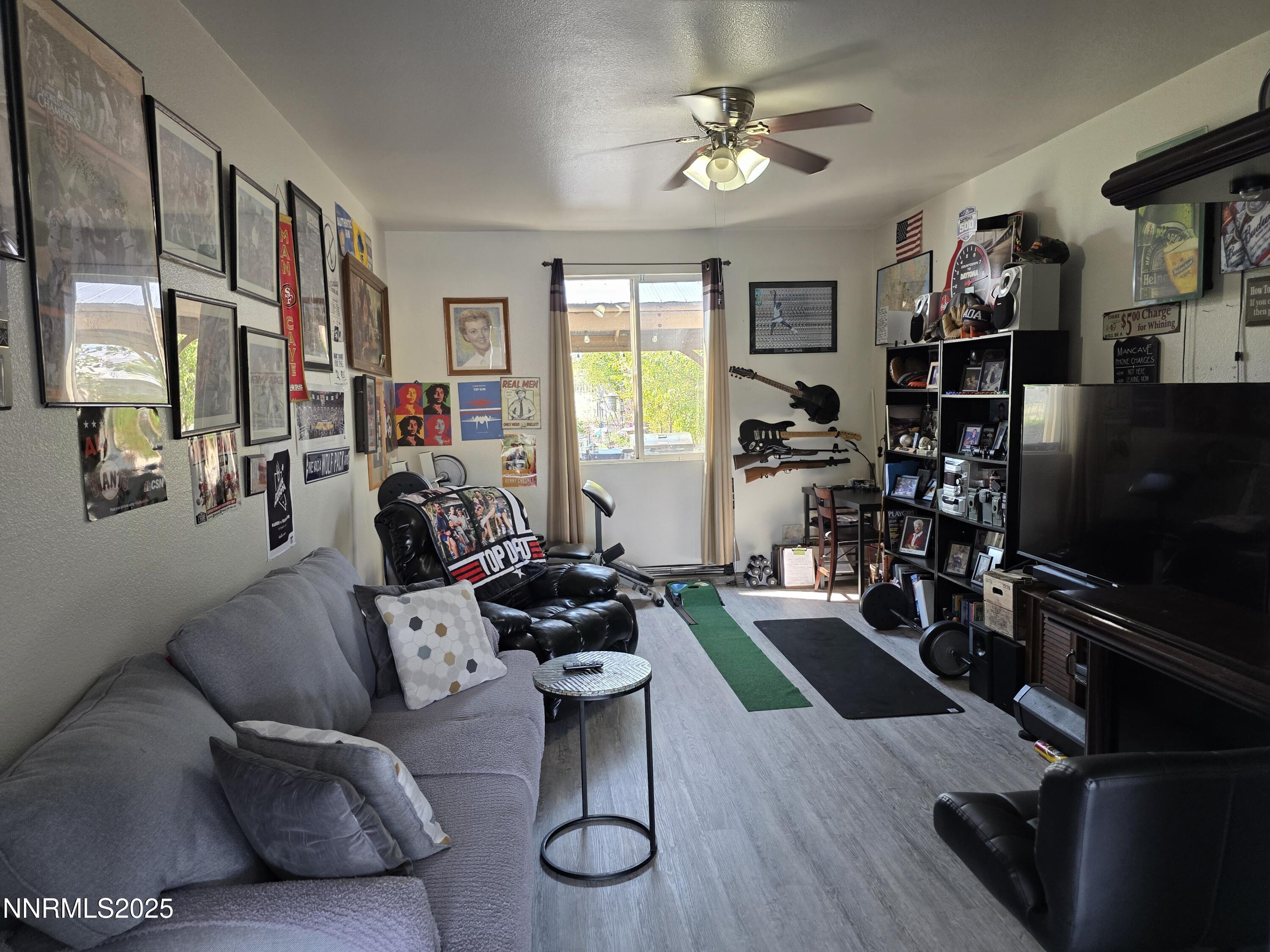 10677 Fire Poppy Circle Reno, NV 89521 - Photo 44 of 45 a living room with furniture a flat screen tv and a window