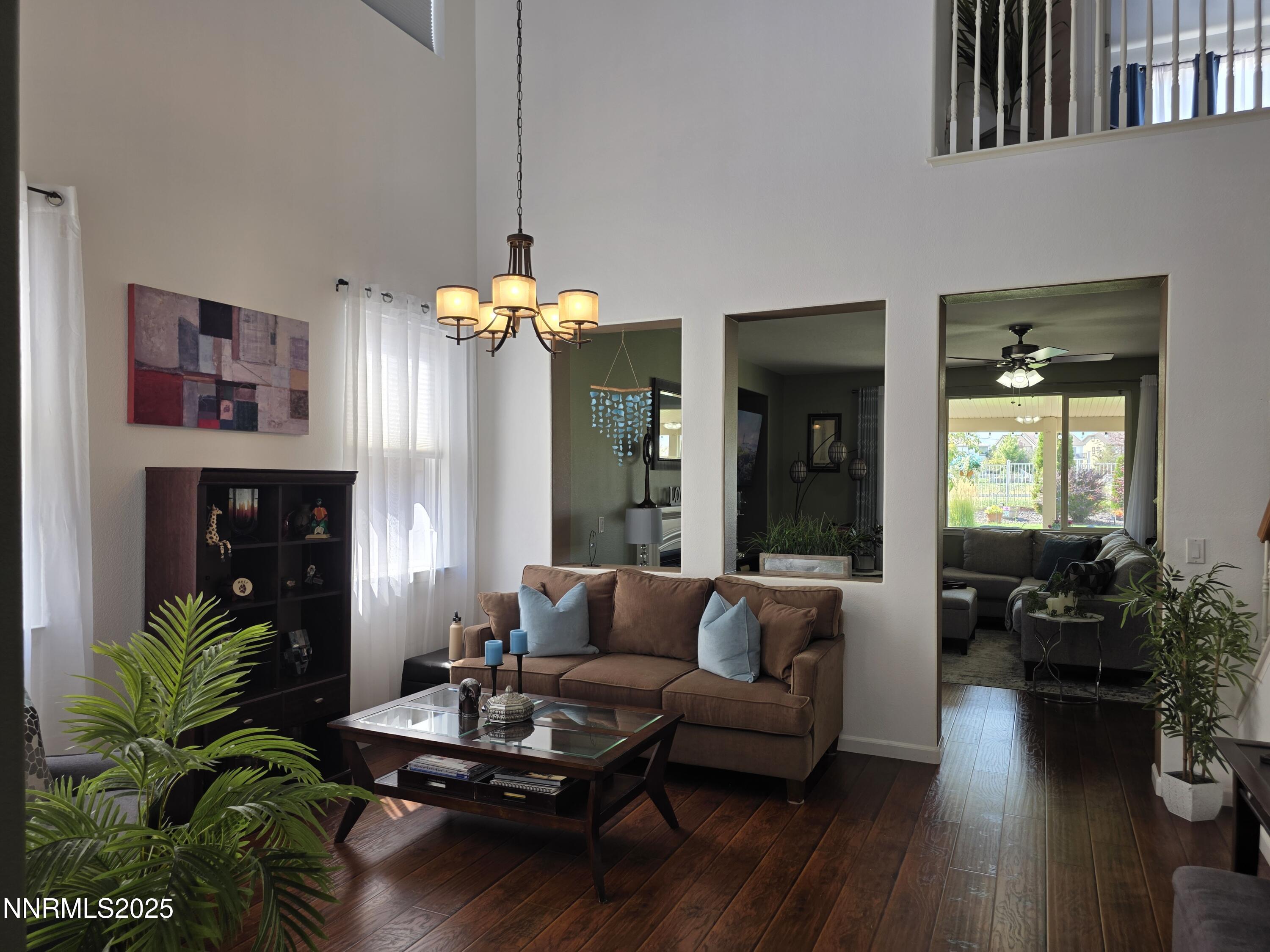 10677 Fire Poppy Circle Reno, NV 89521 - Photo 5 of 45 a living room with furniture and a chandelier