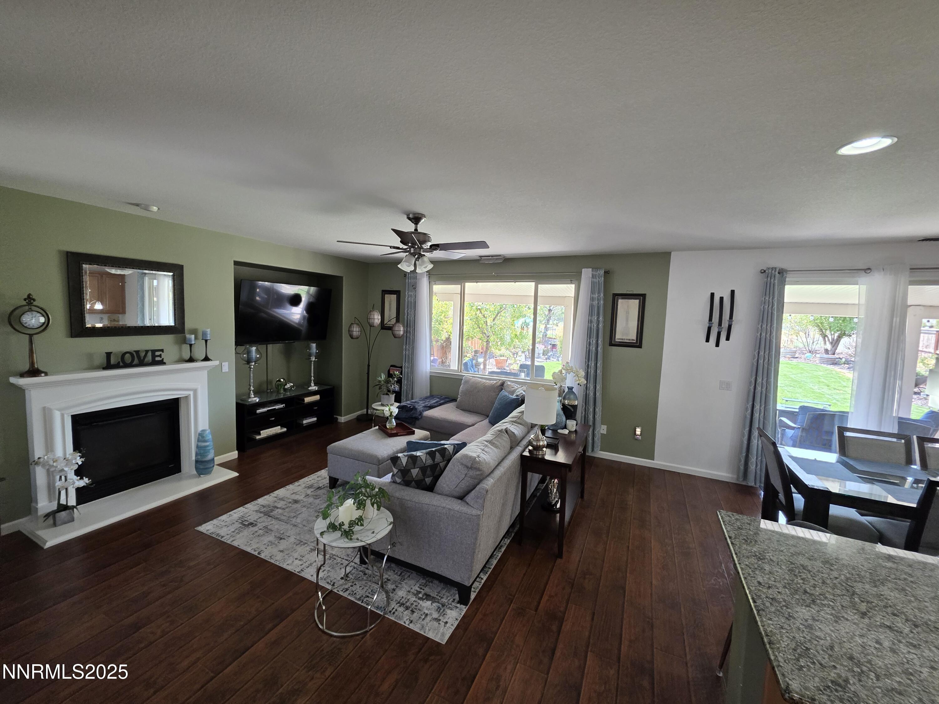 10677 Fire Poppy Circle Reno, NV 89521 - Photo 9 of 45 a living room with furniture and a fireplace