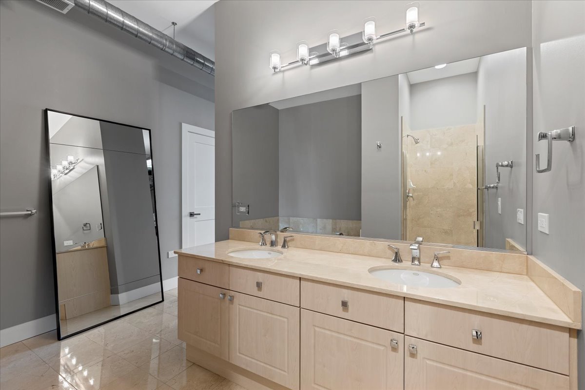 1155 West Madison Street, Unit 603 Chicago, IL 60607 - Photo 15 of 23 a bathroom with a double vanity sink mirror and shower