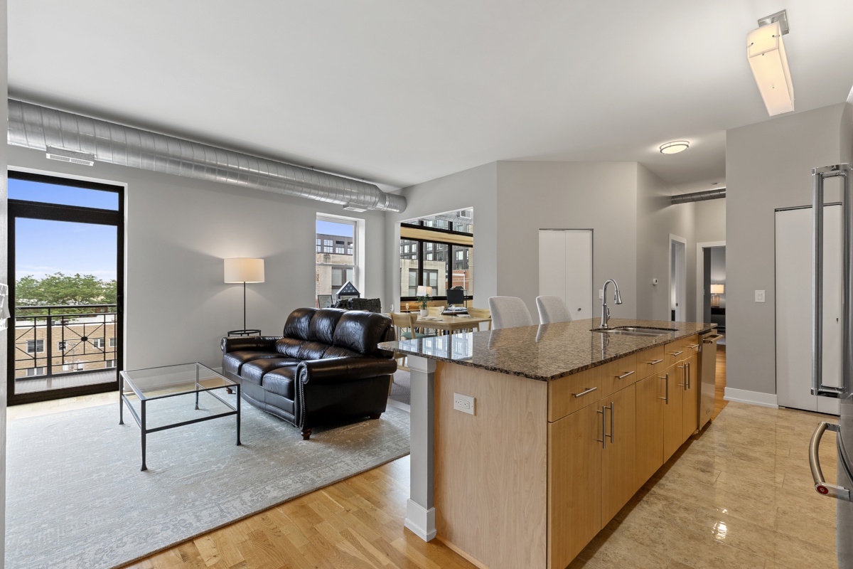 1155 West Madison Street, Unit 603 Chicago, IL 60607 - Photo 5 of 23 a kitchen with granite countertop a sink and counter top space