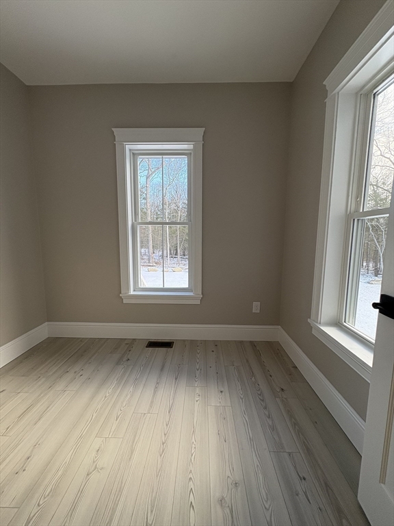 29 Range Avenue Taunton, MA 02780 - Photo 15 of 37 an empty room with wooden floor and windows