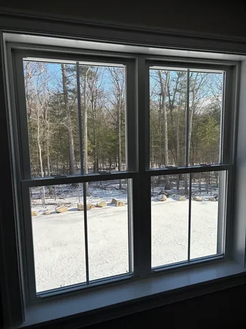 a view of a window and a room with wooden floor