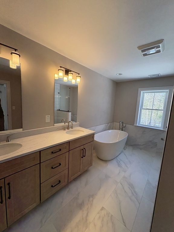 29 Range Avenue Taunton, MA 02780 - Photo 25 of 37 a spacious bathroom with a granite countertop sink and a mirror