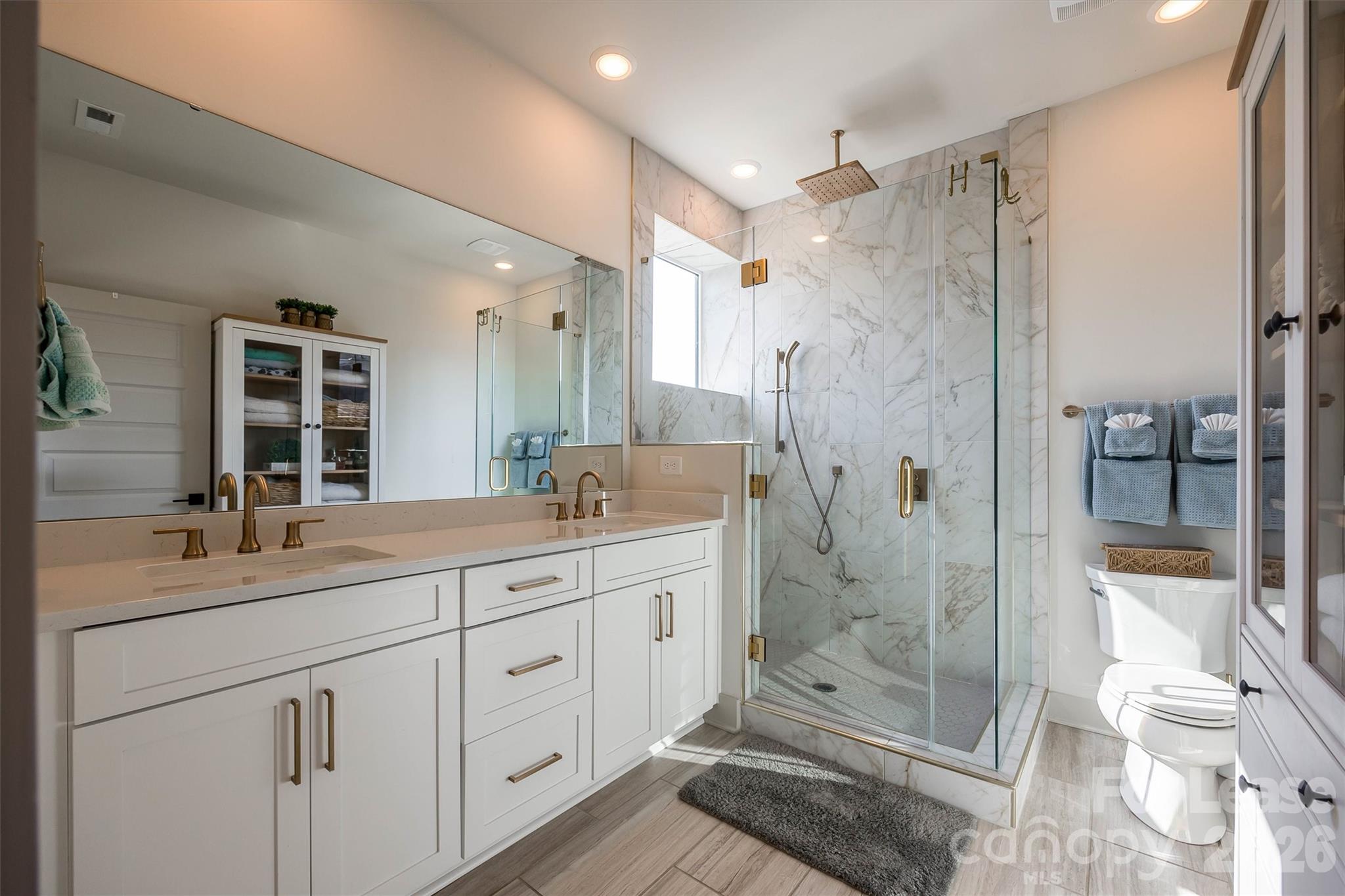 2319 Wesley Village Road Charlotte, NC 28208 - Photo 31 of 44 a spacious bathroom with a shower sink vanity mirror and toilet