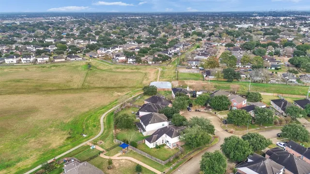 an aerial view of residential houses with outdoor space and river