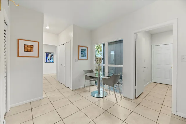 a kitchen with stainless steel appliances granite countertop a stove top oven a sink a refrigerator and white cabinets