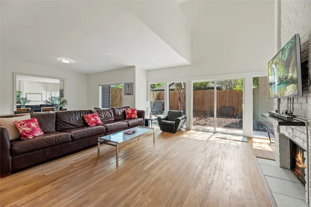 a living room with fireplace furniture and a flat screen tv
