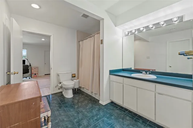 a bedroom with a bed and a couch