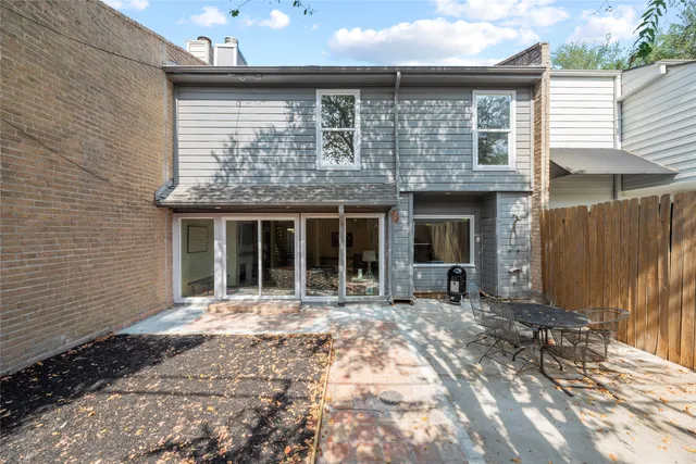 a front view of a house with a garden and patio