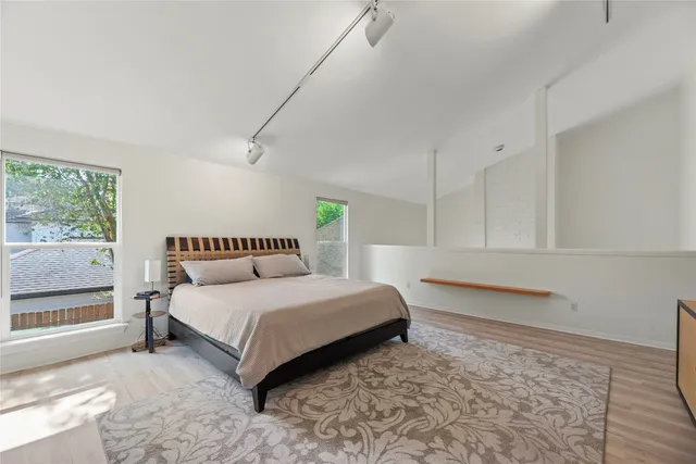 a bedroom with a bed and a window