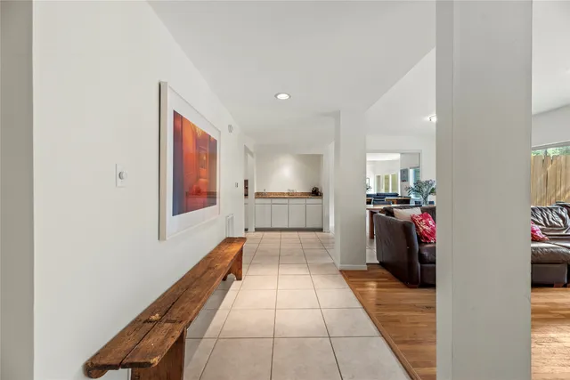 a view of a hallway with wooden floor and furniture