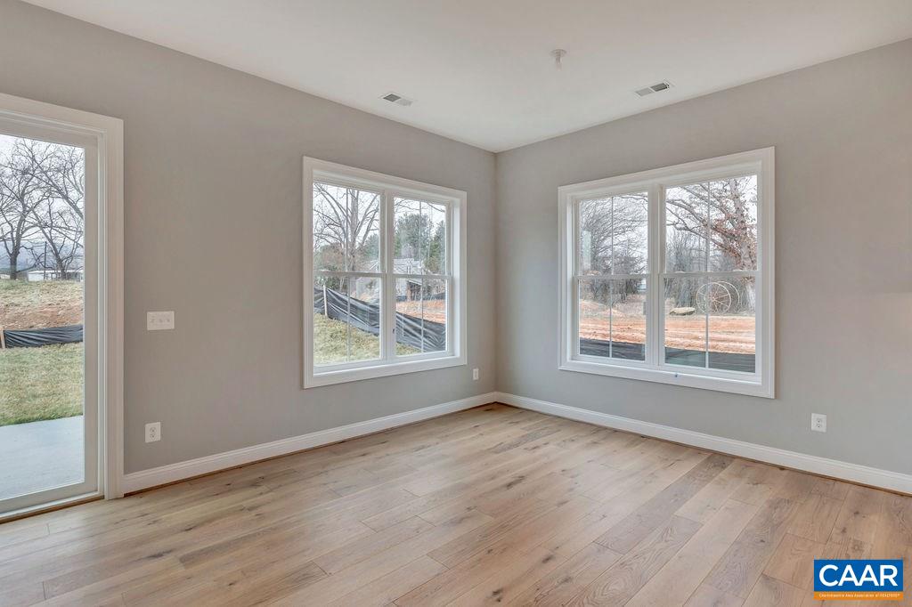 380 Claibourne Road Crozet, VA 22932 - Photo 18 of 25 a view of an empty room with wooden floor and a window
