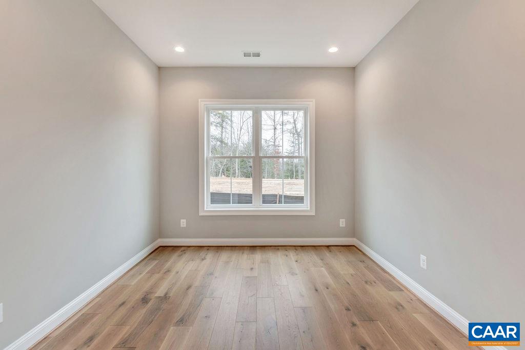 380 Claibourne Road Crozet, VA 22932 - Photo 23 of 25 an empty room with wooden floor and windows