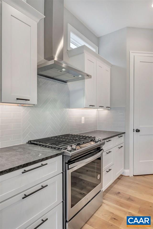380 Claibourne Road Crozet, VA 22932 - Photo 25 of 25 a kitchen with granite countertop white cabinets and stainless steel appliances