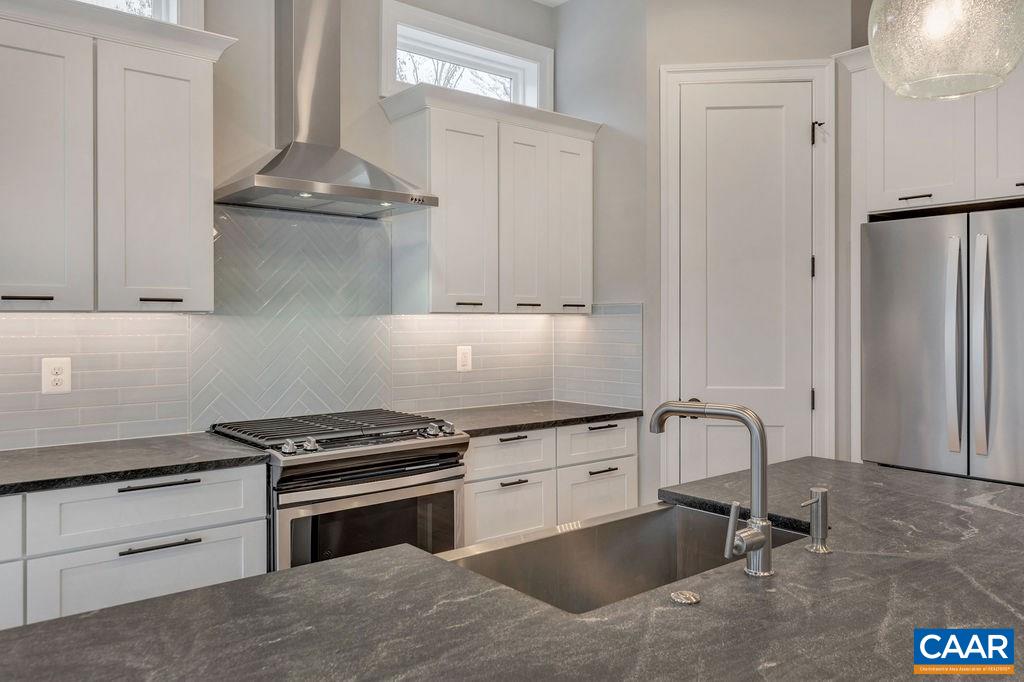 380 Claibourne Road Crozet, VA 22932 - Photo 7 of 25 a kitchen with granite countertop a cabinets and a stove top oven