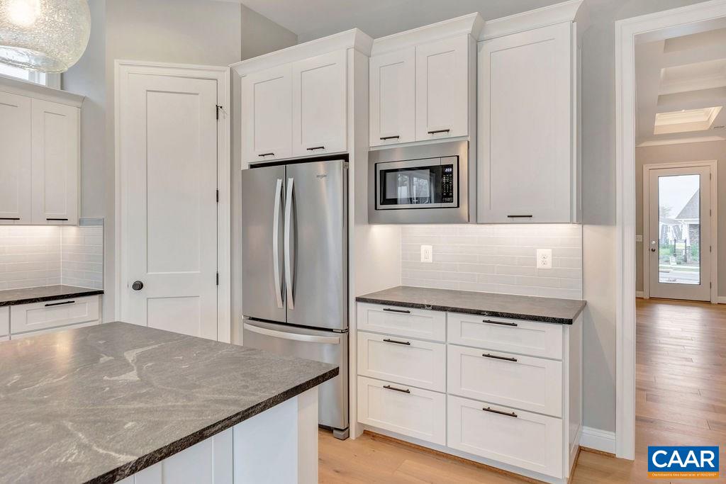 380 Claibourne Road Crozet, VA 22932 - Photo 8 of 25 a kitchen with granite countertop white cabinets and refrigerator