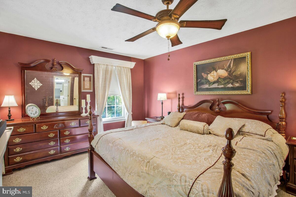 165 Ball Road St. Leonard, MD 20685 - Photo 34 of 55 a bedroom with a large bed and a large mirror