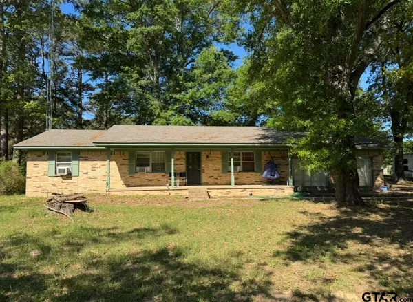 a front view of house with yard outdoor seating and barbeque oven