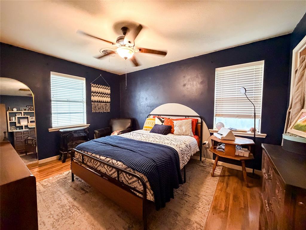 1706 North Ave H Haskell, TX 79521 - Photo 21 of 25 a bedroom with a bed and dresser with mirror
