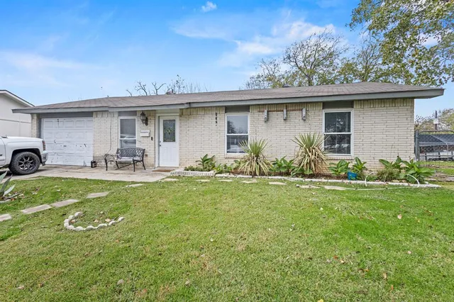 a front view of house with yard seating and green space