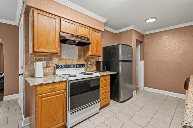 a kitchen with stainless steel appliances granite countertop a sink and a cabinets