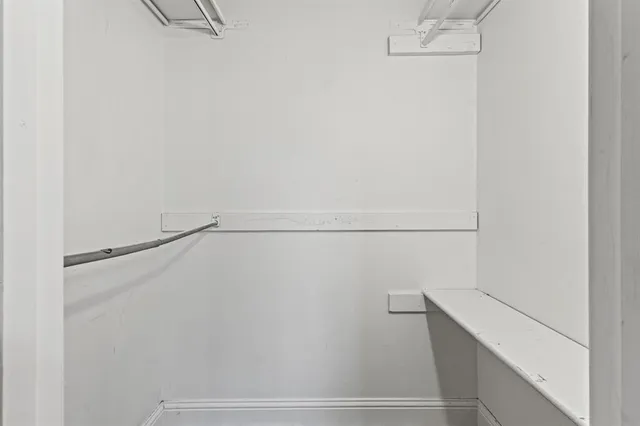 a bedroom with bed and window