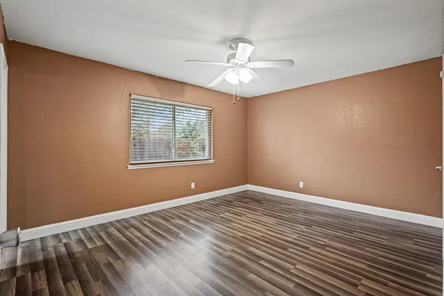 a bathroom with a granite countertop sink vanity mirror and toilet
