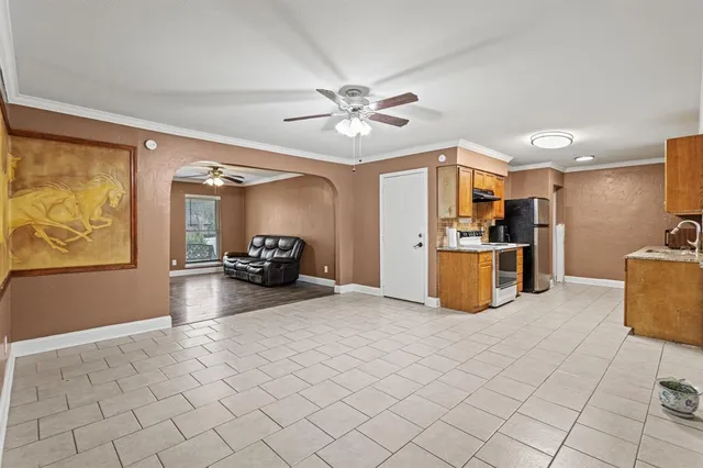 a large kitchen with stainless steel appliances granite countertop a stove a sink and a refrigerator