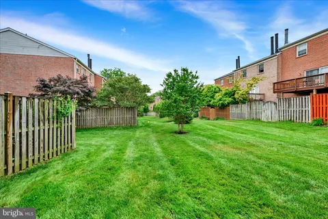 a view of a house with backyard and porch