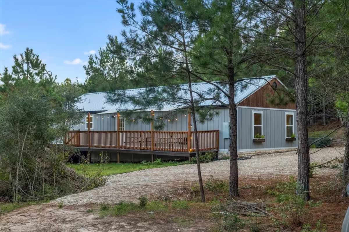 201 Winfield Thicket Road Bastrop, TX 78602 - Photo 4 of 36 a backyard of a house with wooden fence and deck