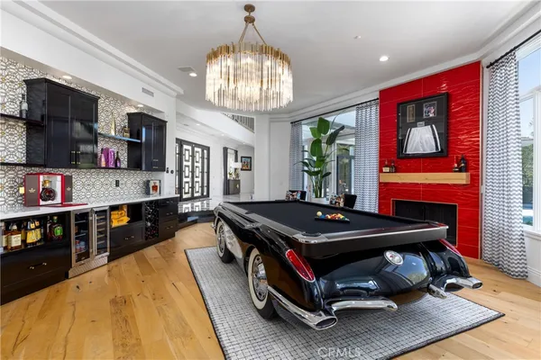 a bedroom with a large bed and a chandelier