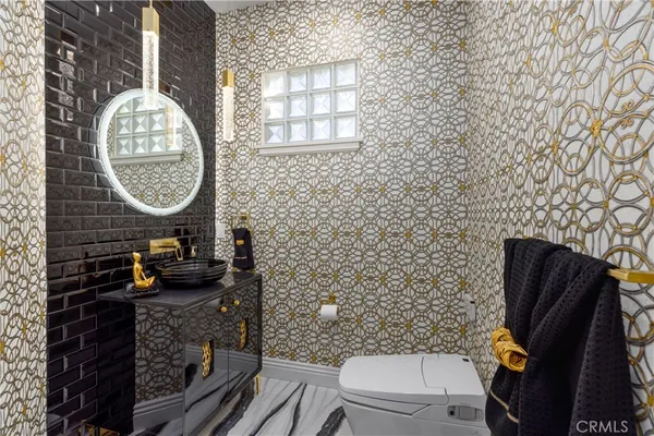 a bathroom with a sink mirror vanity and toilet