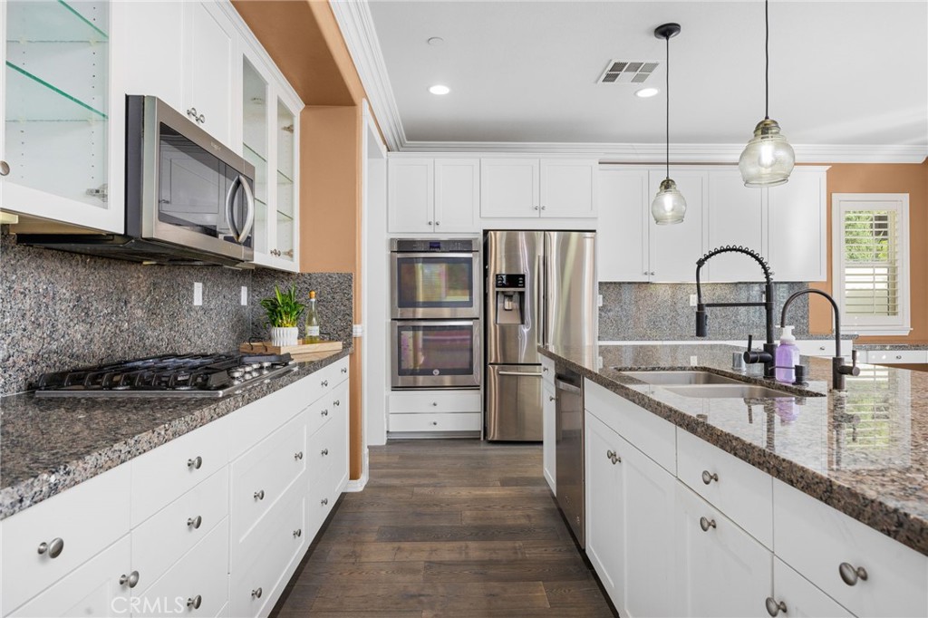 31639 Country View Road Temecula, CA 92591 - Photo 14 of 75 a kitchen with stainless steel appliances granite countertop a sink a stove and refrigerator