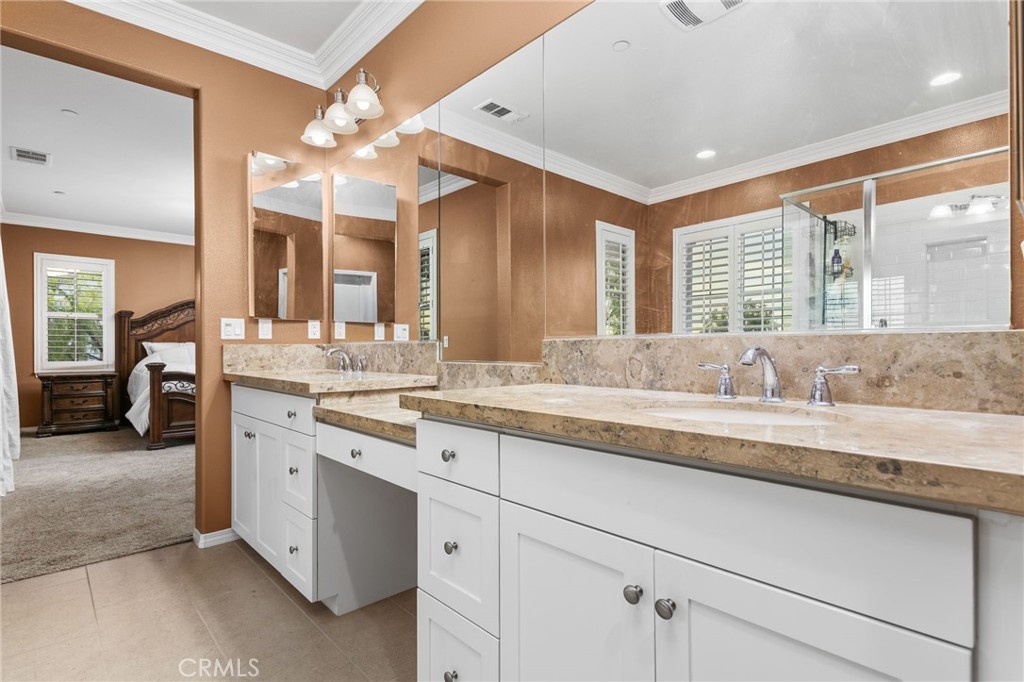 31639 Country View Road Temecula, CA 92591 - Photo 27 of 75 a spacious bathroom with a granite countertop sink and a large mirror