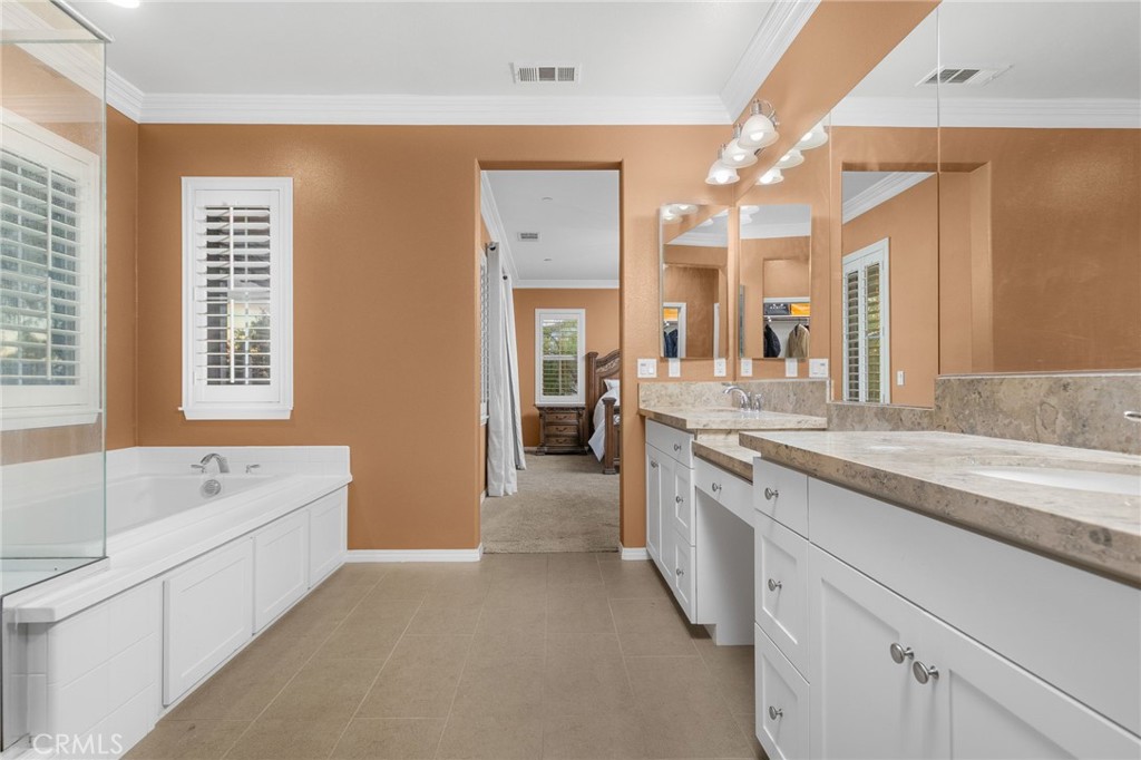 31639 Country View Road Temecula, CA 92591 - Photo 30 of 75 a spacious bathroom with a granite countertop sink mirror and bathtub