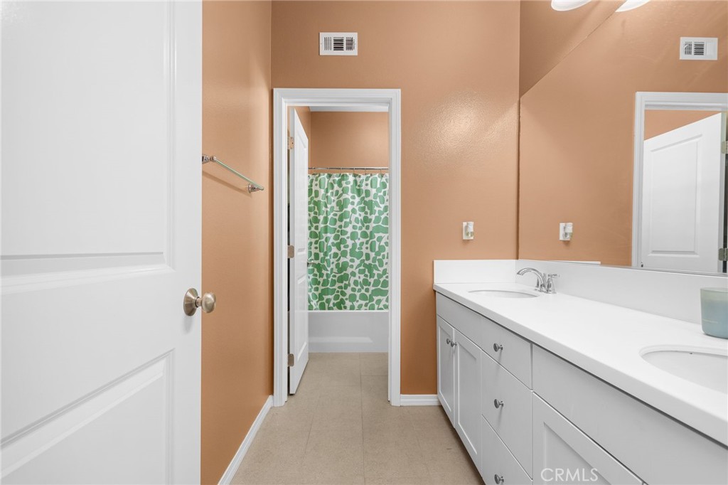 31639 Country View Road Temecula, CA 92591 - Photo 33 of 75 a bathroom with a double vanity sink and mirror
