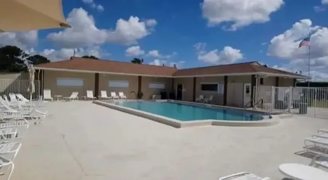 a view of a house with backyard porch and sitting area