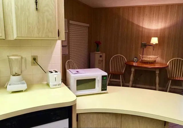 a bedroom with a bed a table and chair