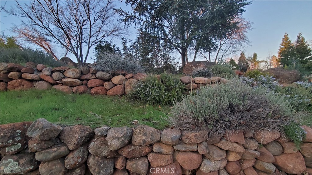116 Valley Ridge Drive Paradise, CA 95969 - Photo 1 of 1 View of rock walls, rosemary, maples, & evergreens.