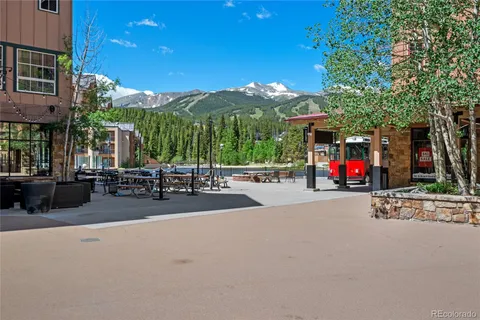 a view of street with tables and chairs
