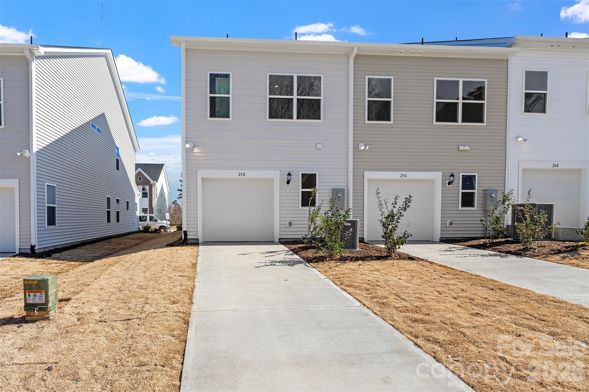 5861 Tuckaseegee Road, Unit 3 Charlotte, NC 28208 - Photo 25 of 28 a front view of a house with a yard
