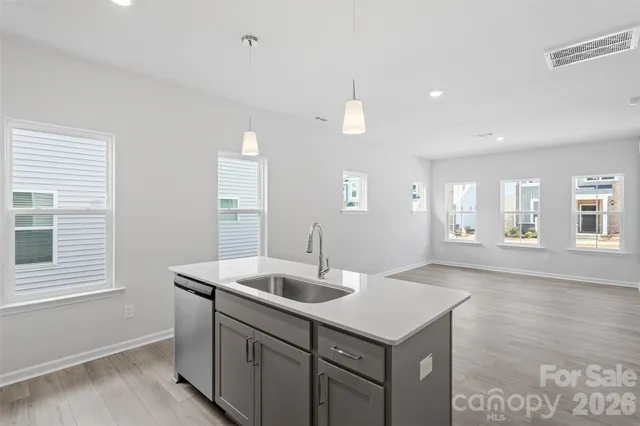 a kitchen with cabinets appliances and a window