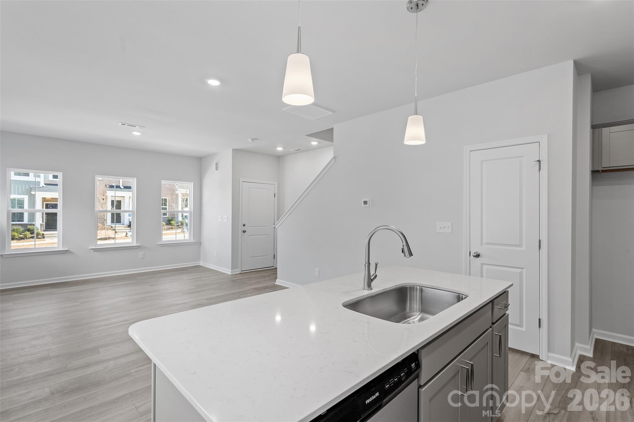 5861 Tuckaseegee Road, Unit 3 Charlotte, NC 28208 - Photo 10 of 28 a kitchen with granite countertop a sink a stove and kitchen island