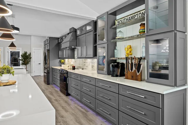 a kitchen with counter top space and wooden floor