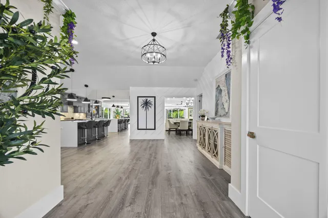 a view of a livingroom with furniture wooden floor a chandelier