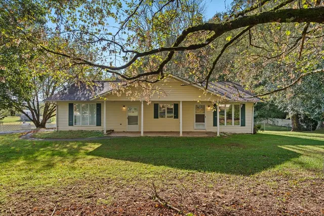 a front view of a house with a garden
